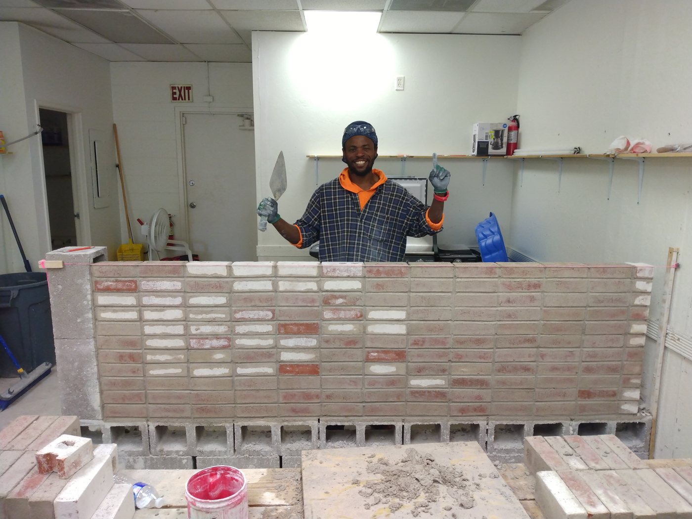 Student with a masonry practice project